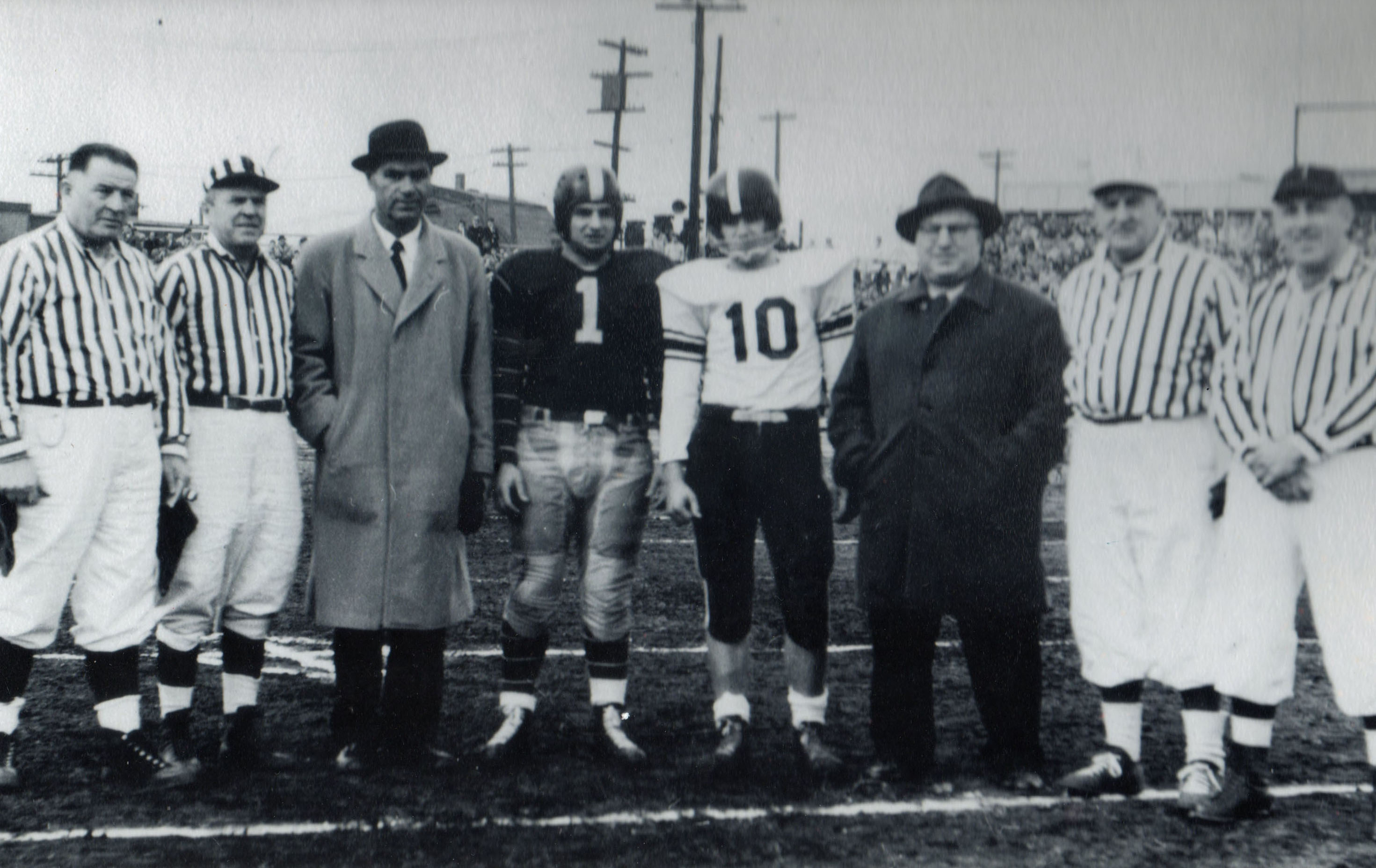 Ben Sarullo (#1) with New Drop coach Sal Somma and Curtis coach Andy Barberi and his captain pose with referees before the Curtis-New Dorp Thanksgiving Day